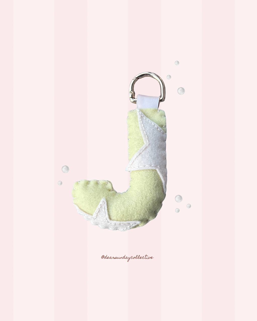 pastel merino wool felt letter keychain with pink & yellow star design and gold metal carabiner, handmade in new zealand.