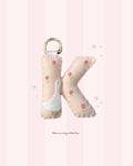 pastel merino wool felt letter keychain with goose and embroidered tulip design and gold metal carabiner, handmade in new zealand.