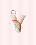 pastel merino wool felt letter keychain/bag charm with a rainbow design and a gold metal carabiner handmade in new zealand. 